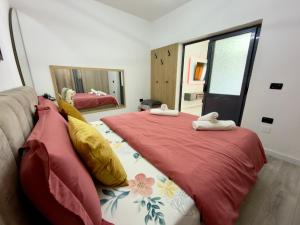 a bedroom with two beds with towels on them at Boku Apartments Pazari i Ri 2 in Tirana