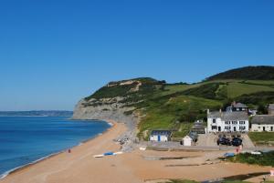 a view of a beach with houses and the ocean at 2 Bed in Chideock oc-g32451 in Chideock +11 photos