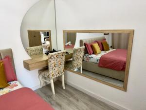 a bedroom with a bed and a mirror at Boku Apartments Pazari i Ri 2 in Tirana