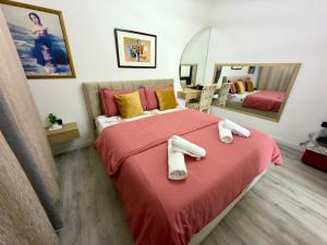 a bedroom with a bed with two towels on it at Boku Apartments Pazari i Ri 2 in Tirana