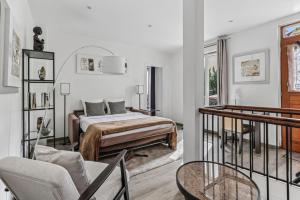 a bedroom with a bed and a balcony with a chair at Loft Fraternité in Bagnolet +15 photos