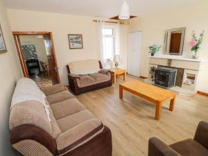 a living room with a couch and a fireplace at Ocean View in Westport
