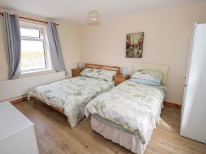a bedroom with two beds and a window at Ocean View in Westport