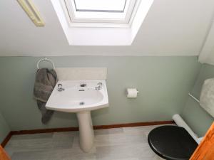 a bathroom with a sink and a toilet at Ocean View in Westport +17 photos
