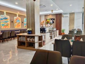 a restaurant with chairs and a table in a room at Front One Luxe Hotel Solo in Solo