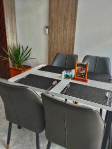 a table with four chairs and a table with at Front One Luxe Hotel Solo in Solo