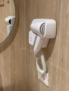 a hair dryer on a wall in a bathroom at Spilea Apartments in Himare