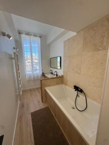 a large bathroom with a tub and a sink at La Bastide des Trembles- Hôtel particulier avec piscine proche IPC et Vélodrome in Marseille +63 photos