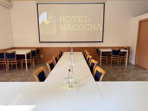 a conference room with a long table and chairs at Hotel Macocha in Blansko