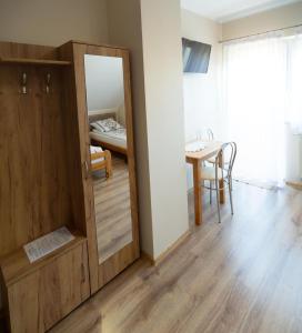 a room with a mirror and a table with a bed at Zajazd u ELiZY in Czajowice