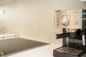 a coffee maker sitting on top of a counter at Anemoessa House in Pera Gyalos +66 photos