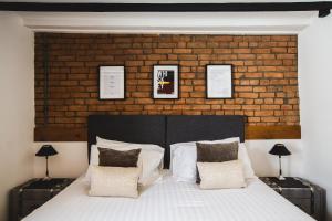 a bedroom with a large bed with a brick wall at No.8 Accommodation in Chepstow