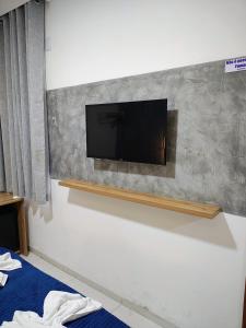 a flat screen tv mounted on a wall at Hotel Da Orla in Aracaju