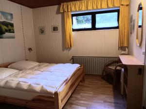a bedroom with a large bed and a window at Ferienwohnung Sausen in Kröv