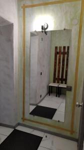 a mirror in a room with a sink and two benches at Подобово Центр in Konotop