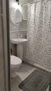a bathroom with a toilet and a sink and a shower at Подобово Центр in Konotop