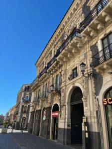 a large stone building on a city street at San Demetrio in Catania