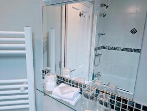 a bathroom with a glass counter with a mirror at Lee House in Lynton +69 photos
