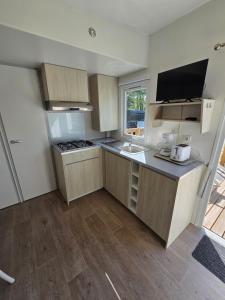 a small kitchen with a sink and a counter at camping la plage de l'orb in Cessenon +18 photos