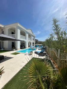 a villa with a swimming pool and a resort at Willa Casa Blanca in Pag