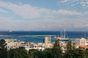 a city with buildings and the ocean in the background at Panoramic Loft in Chios +42 photos