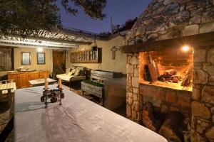 a kitchen with a stone fireplace with a table and candles at Duivenvlugt Loft in Stilbaai