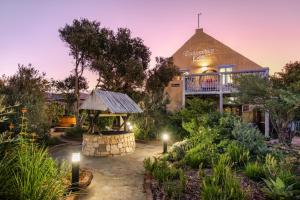 a building with a gazebo in a garden at Duivenvlugt Loft in Stilbaai