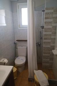 a bathroom with a toilet and a shower with a window at G. Kiapekou in Loutra Edipsou +40 photos