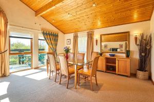 a dining room with a glass table and chairs at Host & Stay - Lodge 32 in Belton +25 photos