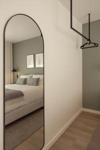 a bedroom with a mirror and a bed at Casa Jacinto 9 in Caldas da Rainha