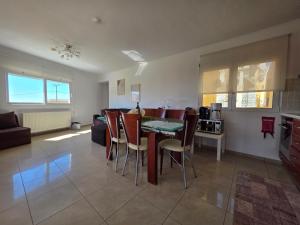 a kitchen and living room with a table and chairs at Peramos Sea View in Nea Peramos