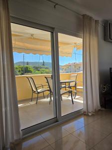 a view of a balcony with a table and chairs at Peramos Sea View in Nea Peramos