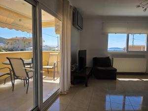a living room with a couch and a table and chairs at Peramos Sea View in Nea Peramos