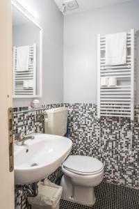 a bathroom with a white toilet and a sink at La Stanza Rossa alle Cinque Terre in Manarola