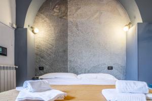 a bedroom with a bed and a stone wall at La Stanza Rossa alle Cinque Terre in Manarola
