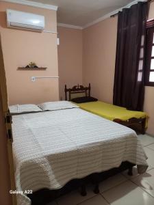 a bedroom with two beds and a window at FL Acomodações in Crato