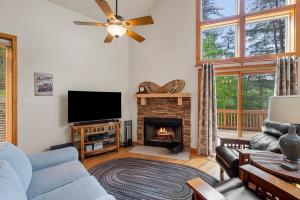 a living room with a tv and a fireplace at Shenandoah A-Frame Chalet at Bryce Resort in Basye