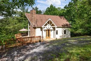 a small white house with a porch and a deck at Shenandoah A-Frame Chalet at Bryce Resort in Basye