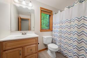 a bathroom with a sink and a toilet and a shower curtain at Shenandoah A-Frame Chalet at Bryce Resort in Basye +36 photos