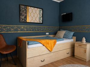 a bedroom with a bed and a tv on a wall at Pension ElbeStay in Königstein an der Elbe