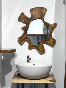 a bathroom with a sink and a mirror at Terima Kasih Malang Hostel in Malang