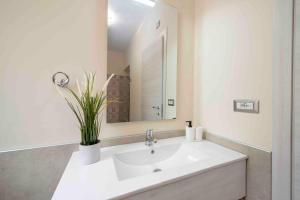 a bathroom with a white sink and a mirror at Coastal Escape, Amalfi in San Lazzaro Agerola +32 photos