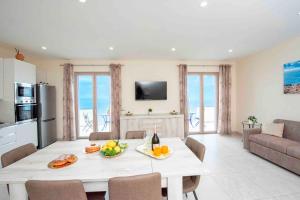 a kitchen and living room with a table with fruit on it at Coastal Escape, Amalfi in San Lazzaro Agerola