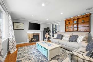a living room with a couch and a fireplace at Dog-Friendly Cape Cod Getaway with Fire Pit Yard in South Yarmouth