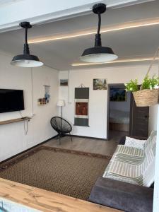 a living room with two pendant lights and a couch at The Bay Area in Cholpon-Ata