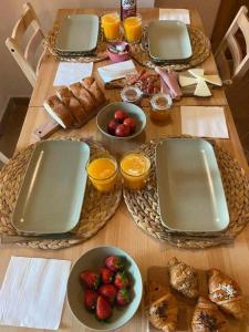 a table with plates of food and fruit on it at Can Passarells in San Vicente de Torelló