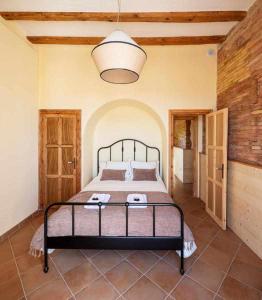 a bedroom with a bed in a room at Can Passarells in San Vicente de Torelló +29 photos