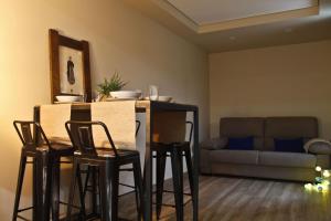 a living room with a table with chairs and a couch at Mendiko Baserria in Amurrio