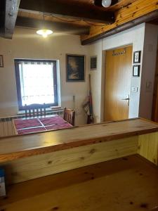 a large wooden counter in a room with a window at Bovec Center Stay in Bovec