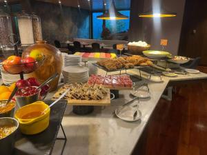 a buffet with many different types of food on a table at Courtyard by Marriott Puerto Montt in Puerto Montt